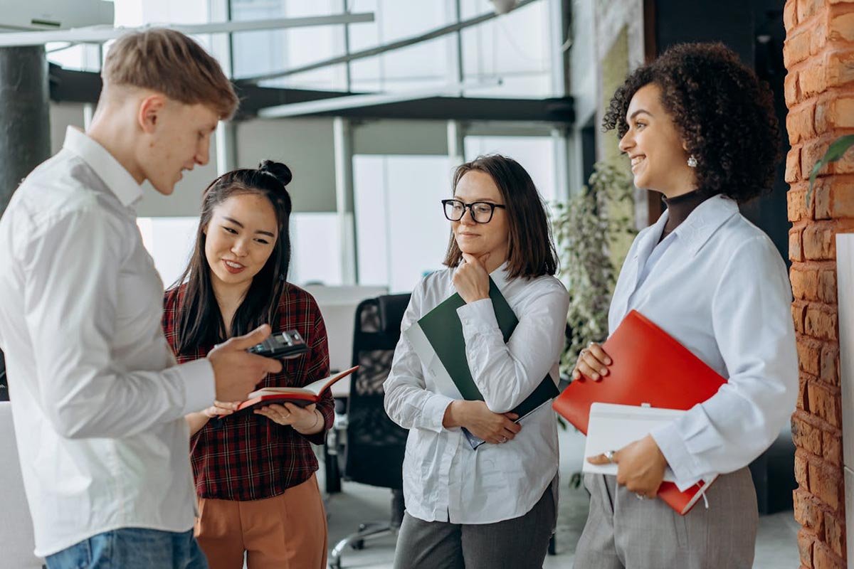 Photo by Mikhail Nilov: https://www.pexels.com/photo/photograph-of-coworkers-talking-8297448/ A group of people attending a Czech language course in Prague