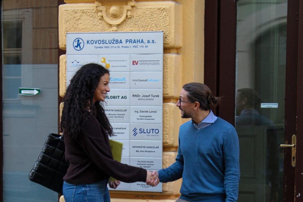 The Italian teacher and founder of Language Atelier school is shaking the hand of a new Italian student who wants to learn and study Italian in Prague