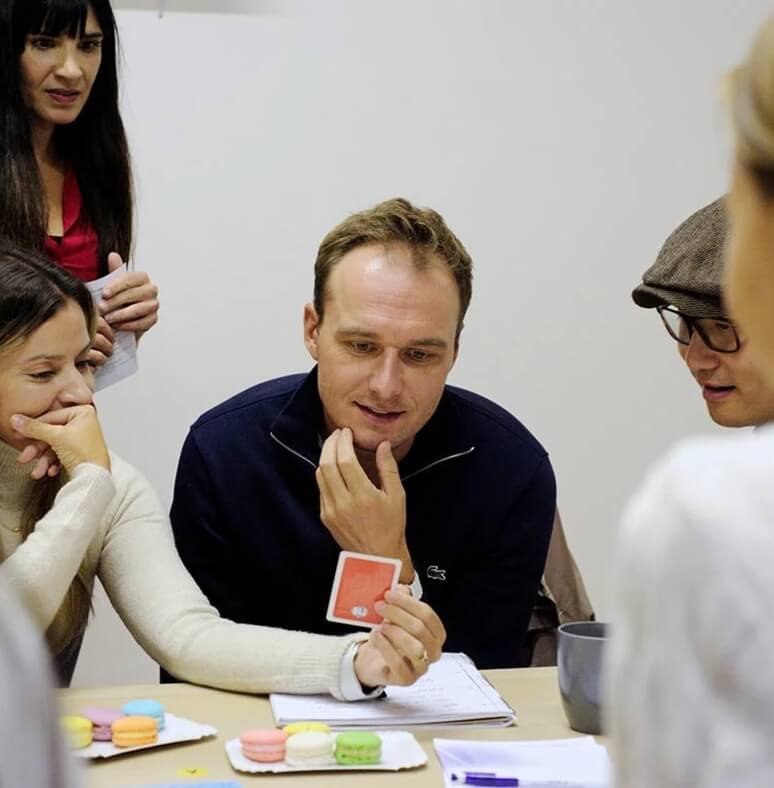 Students playing a card-based language game in class