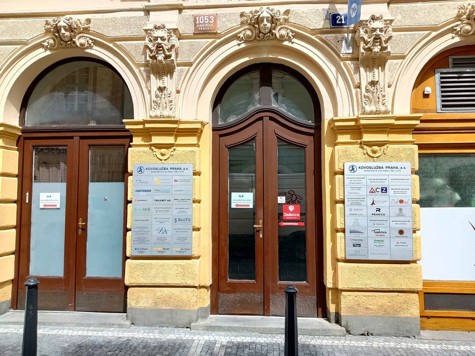Entrance of Language Atelier school in a historic yellow building in Prague