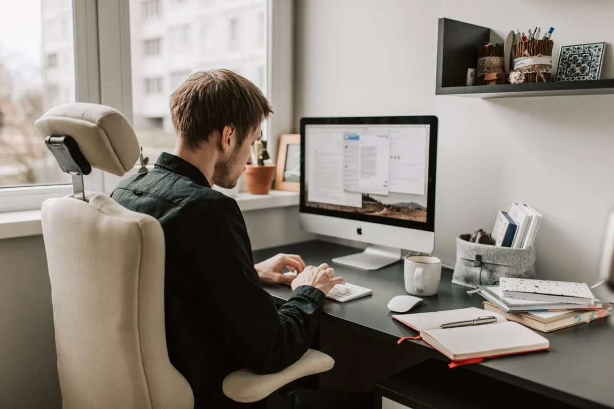 Man attending an online language class from a home office setup