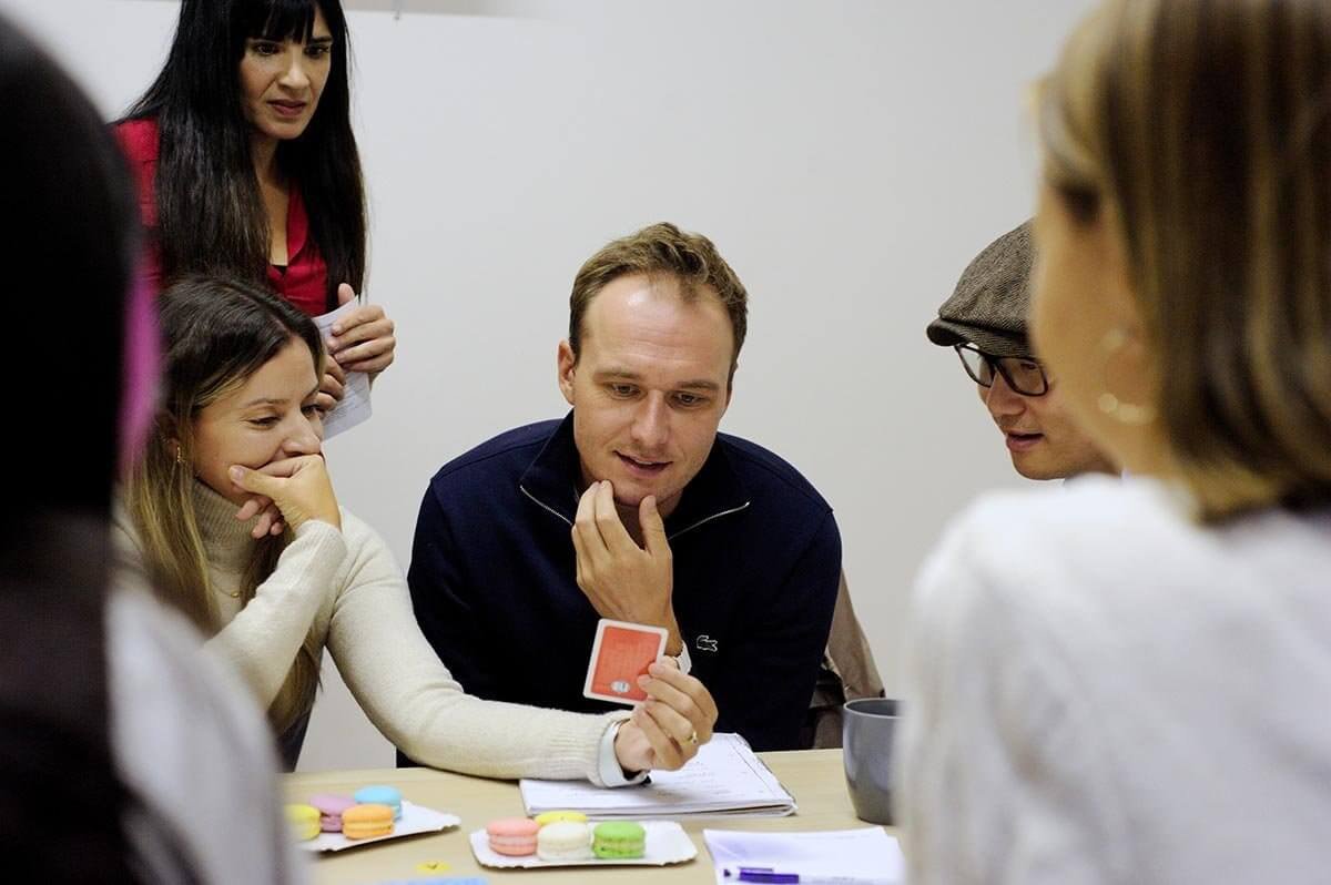 Students learning Spanish with a card game in a fun class setting