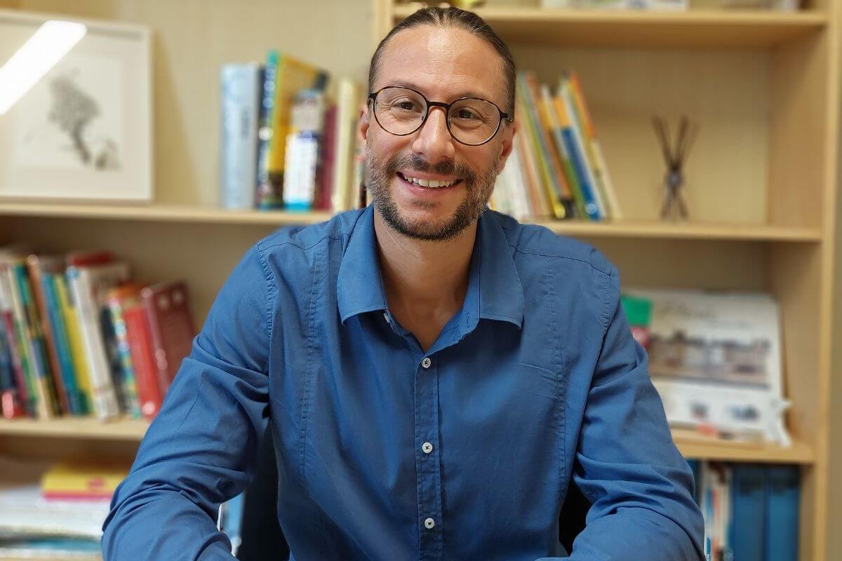 Student learning online with earphones and coffee